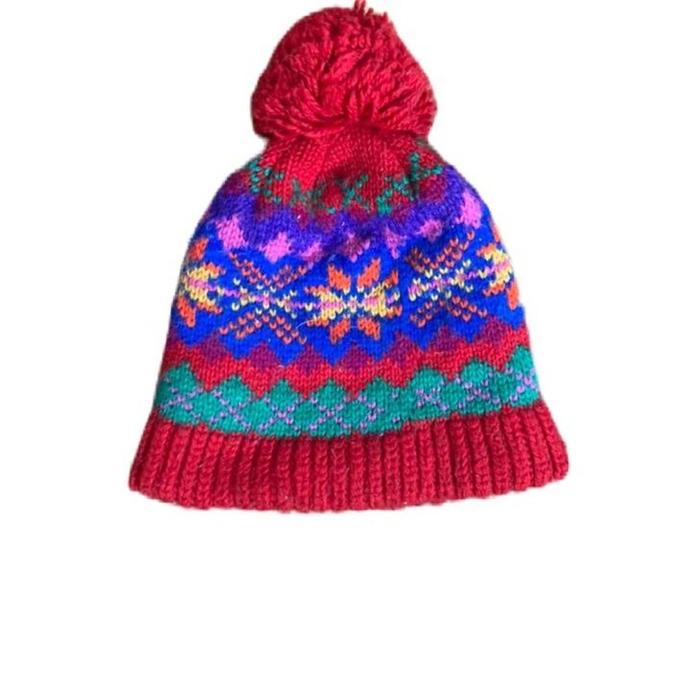Colorful knit winter beanie with red pompom